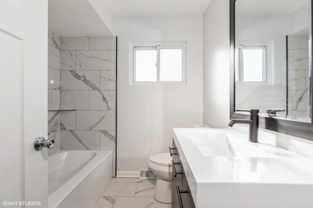 full bathroom with vanity, toilet, and tiled shower / bath