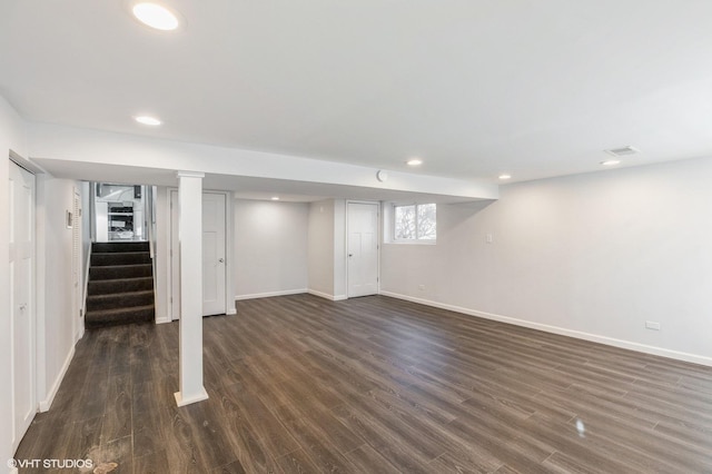 basement with dark hardwood / wood-style flooring