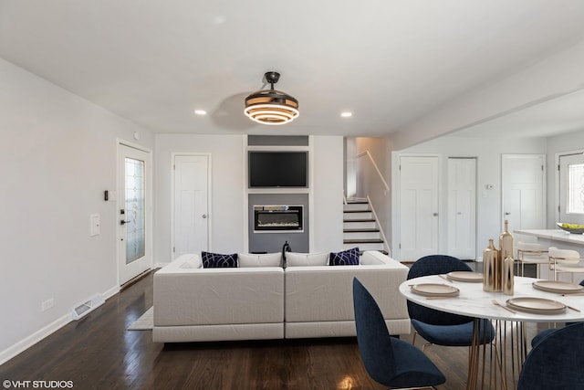 living room with dark hardwood / wood-style flooring