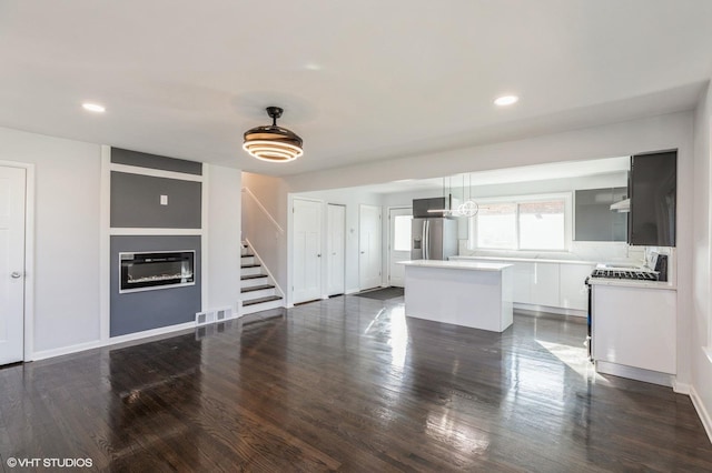 unfurnished living room with dark hardwood / wood-style floors