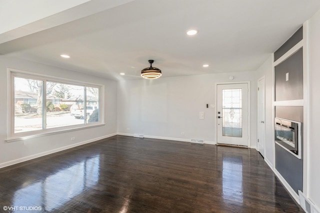 unfurnished living room with dark hardwood / wood-style floors