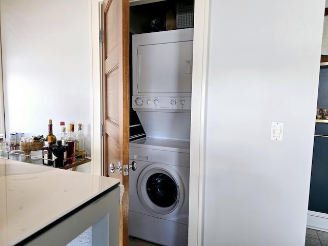 laundry area featuring stacked washer and dryer