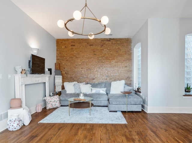 living room with an inviting chandelier, a healthy amount of sunlight, and dark hardwood / wood-style floors