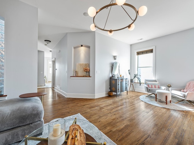 living room featuring hardwood / wood-style flooring and a chandelier