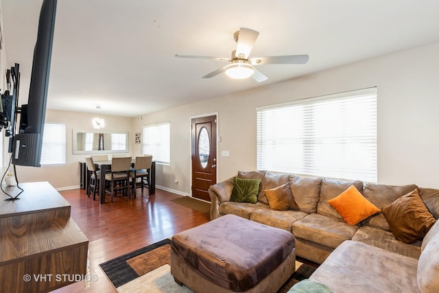 living room with ceiling fan and dark hardwood / wood-style flooring