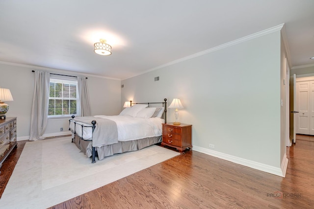 bedroom with crown molding and hardwood / wood-style flooring