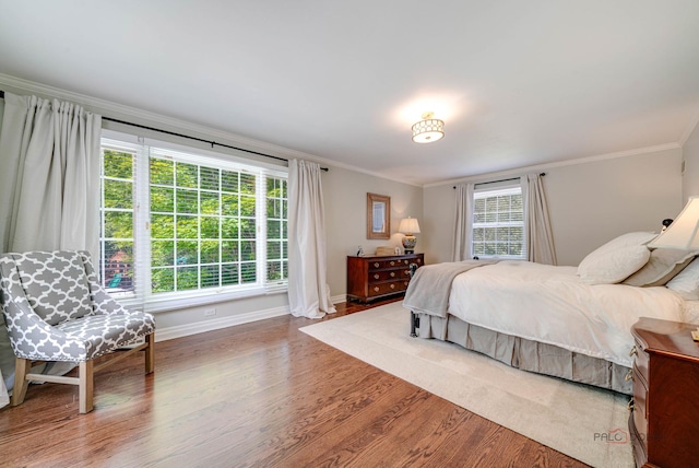 bedroom featuring wood-type flooring and crown molding