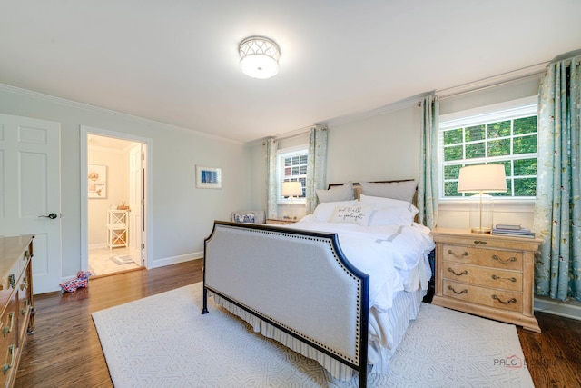 bedroom with crown molding and dark hardwood / wood-style floors