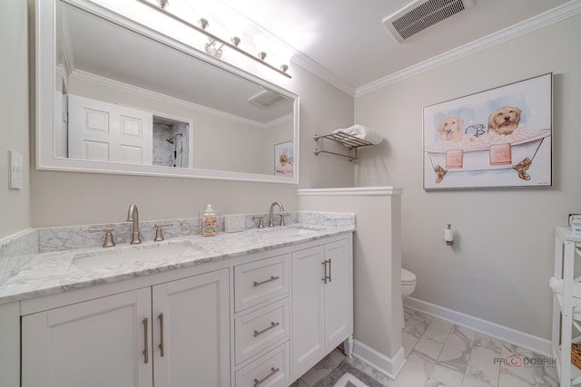 bathroom with crown molding, vanity, and toilet