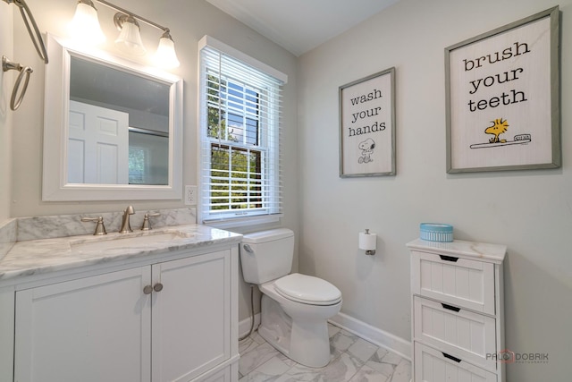 bathroom featuring vanity and toilet