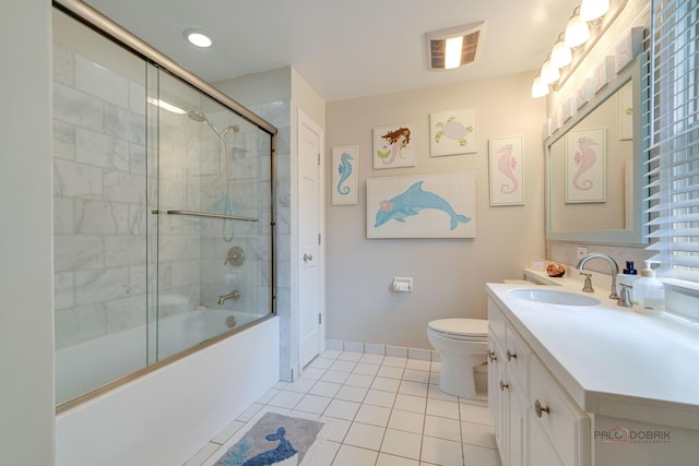 full bathroom with vanity, tile patterned flooring, shower / bath combination with glass door, and toilet