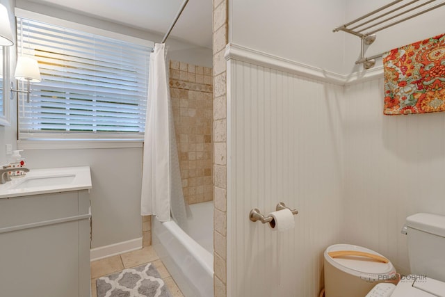 full bathroom featuring tile patterned flooring, vanity, toilet, and shower / bath combo with shower curtain