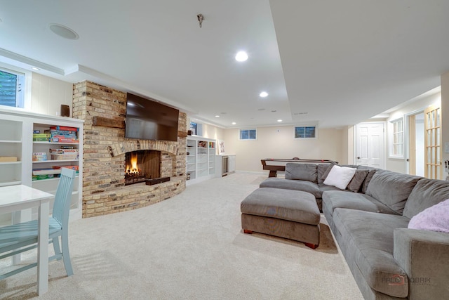 living room featuring a brick fireplace, light colored carpet, and billiards