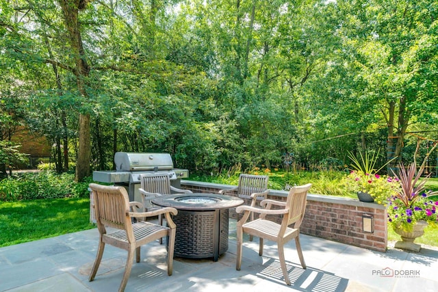 view of patio featuring a fire pit and grilling area