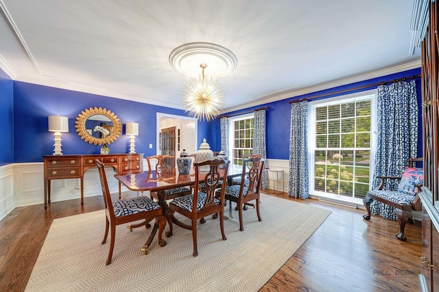 dining space with crown molding, plenty of natural light, a chandelier, and hardwood / wood-style floors