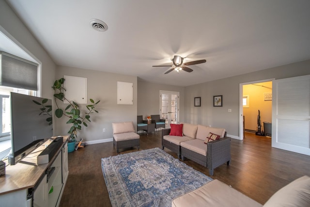 living room with dark wood-type flooring, ceiling fan, and french doors