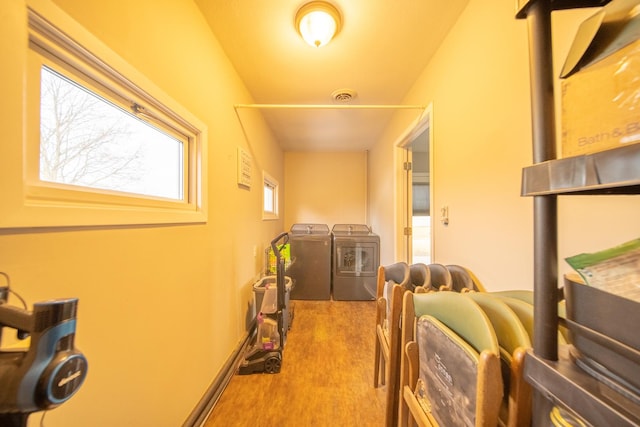 laundry area with hardwood / wood-style floors and independent washer and dryer