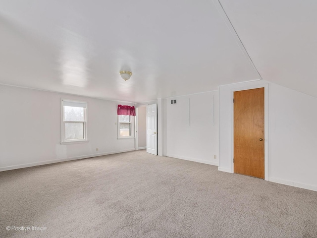 spare room featuring lofted ceiling and carpet floors