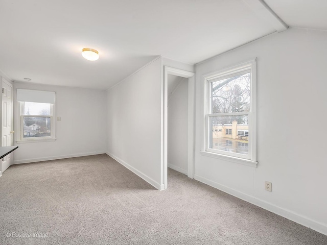 interior space with vaulted ceiling, carpet floors, and a wealth of natural light