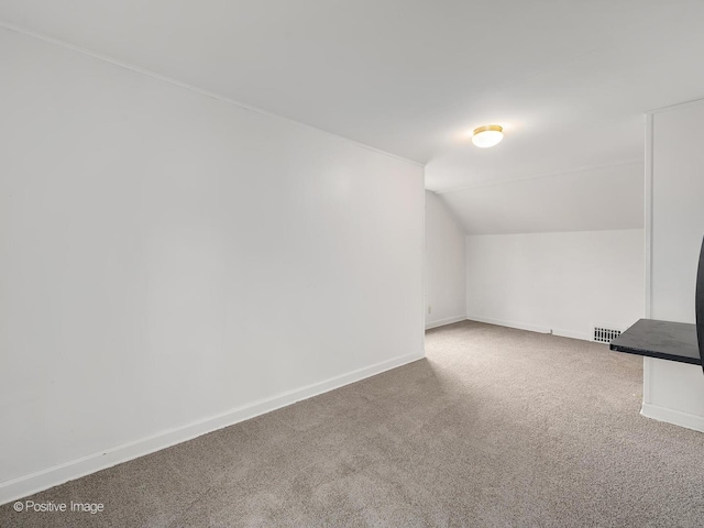 bonus room featuring carpet floors and vaulted ceiling