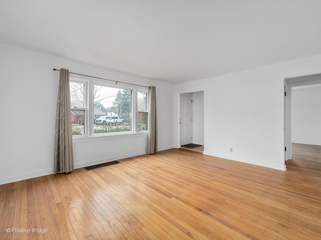 empty room with light hardwood / wood-style flooring