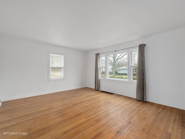 unfurnished room featuring light hardwood / wood-style floors and a healthy amount of sunlight