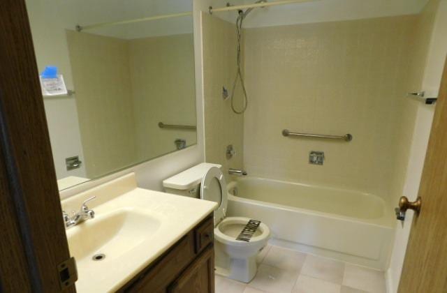 full bathroom with vanity, tile patterned floors,  shower combination, and toilet