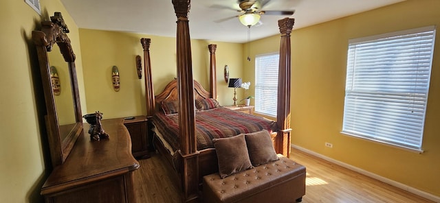 bedroom featuring light wood-type flooring, baseboards, visible vents, and ceiling fan