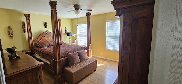 bedroom with baseboards, light wood-type flooring, and ceiling fan