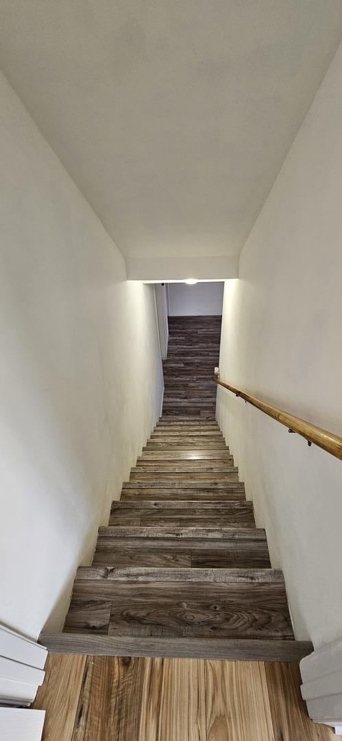 stairway with wood finished floors