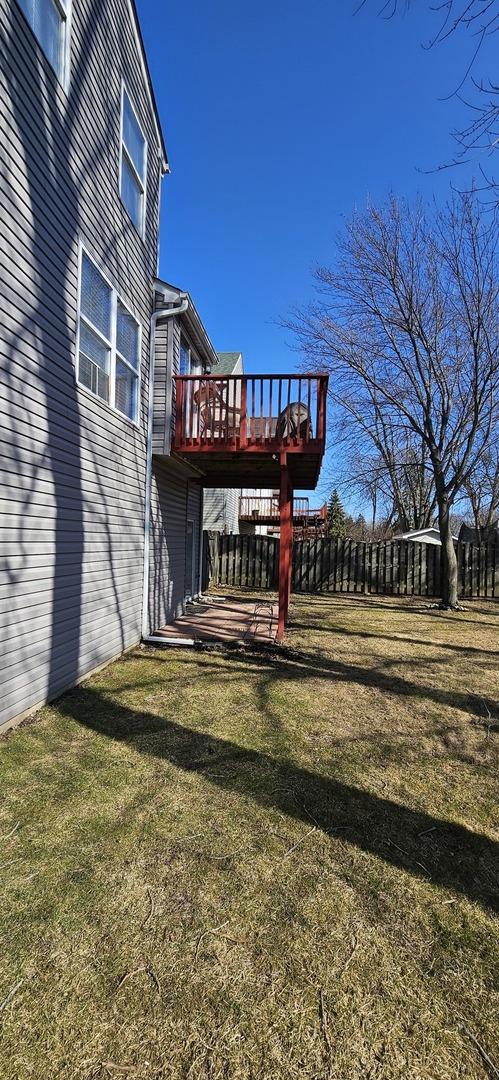 view of yard featuring a deck and fence