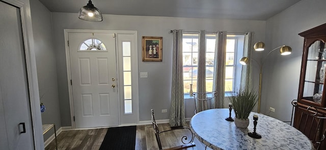 entrance foyer featuring baseboards and dark wood-style flooring