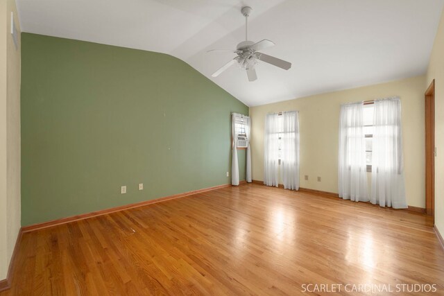 spare room with ceiling fan, lofted ceiling, and light wood-type flooring