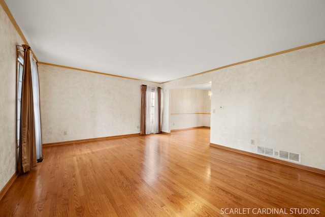 unfurnished room featuring ornamental molding and hardwood / wood-style floors