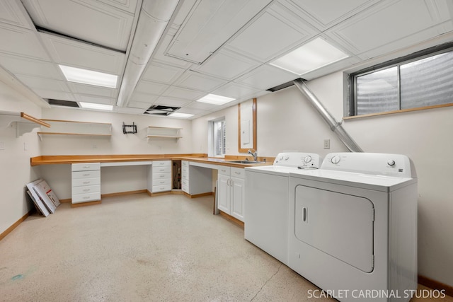 laundry area with sink, washing machine and dryer, and cabinets