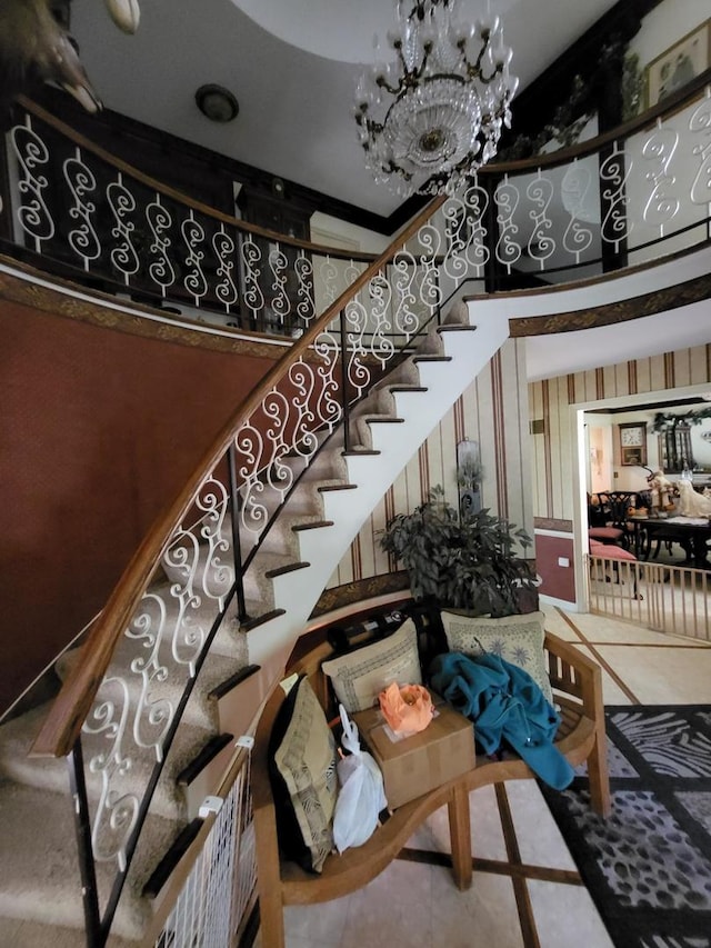 stairway with a towering ceiling and a chandelier