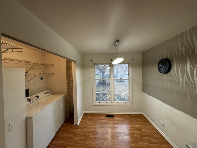 washroom featuring washer and dryer and dark wood-type flooring