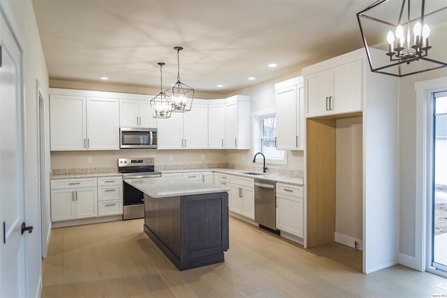 2500 Taylor Dr, Quincy, IL 62305 - kitchen featuring appliances with stainless steel finishes, a chandelier, a sink, plenty of natural light, and recessed lighting