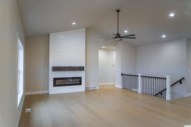 2500 Taylor Dr, Quincy, IL 62305 - unfurnished living room with a ceiling fan, wood finished floors, vaulted ceiling, a large fireplace, and baseboards