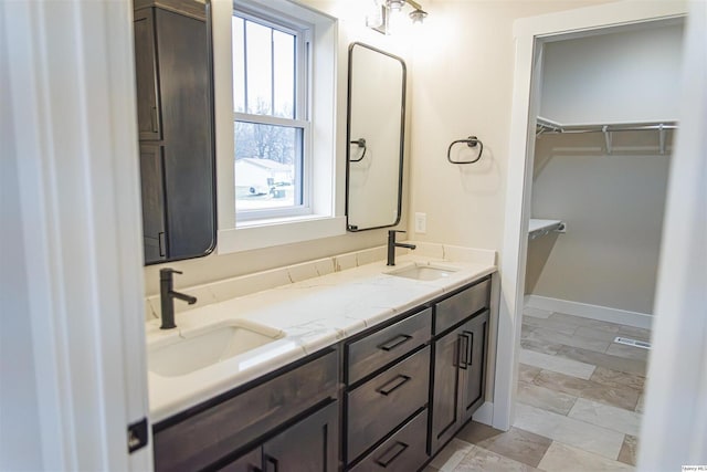 2500 Taylor Dr, Quincy, IL 62305 - full bath with a walk in closet, double vanity, and baseboards