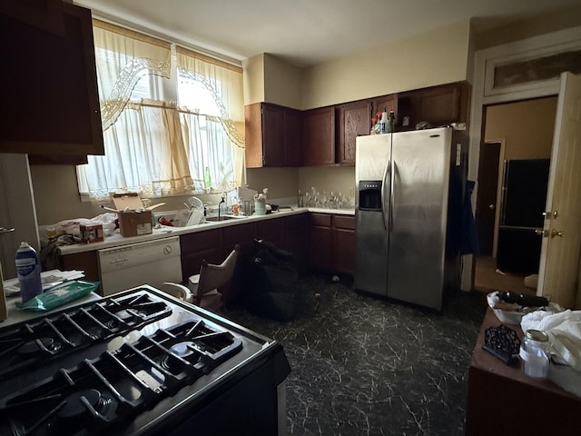 kitchen featuring dishwasher, sink, dark brown cabinetry, stainless steel fridge with ice dispenser, and gas stove