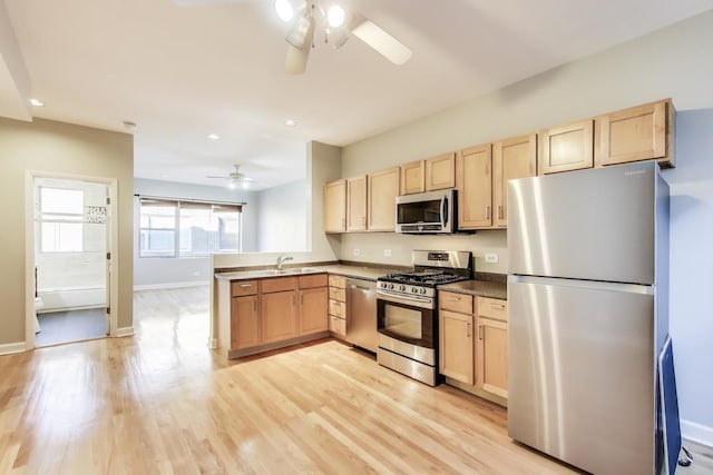 kitchen with sink, ceiling fan, stainless steel appliances, light hardwood / wood-style floors, and light brown cabinetry