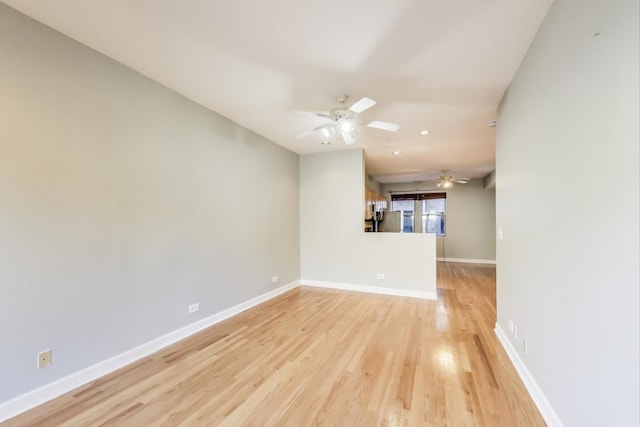 unfurnished room with ceiling fan and light wood-type flooring