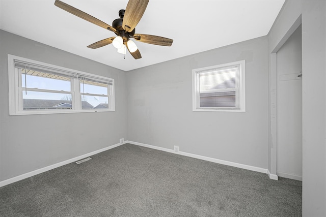 carpeted spare room with ceiling fan