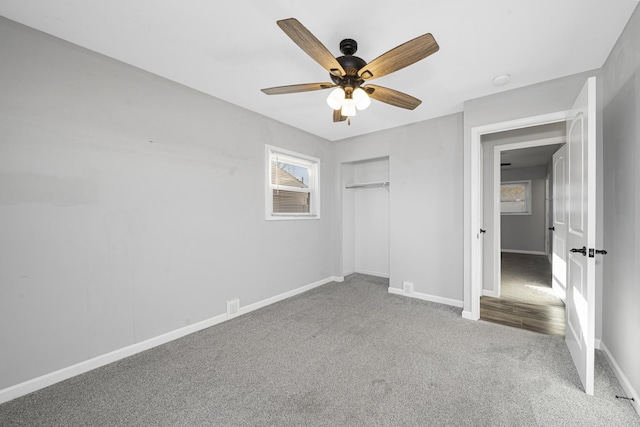 unfurnished bedroom featuring ceiling fan, a closet, and carpet