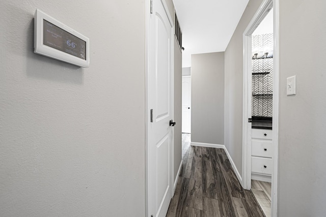 hallway featuring dark hardwood / wood-style flooring