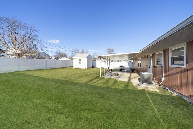 view of yard featuring central AC, a storage shed, and a patio area