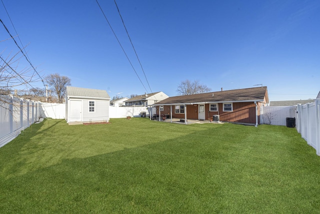 rear view of house featuring a yard, central AC, and a storage unit