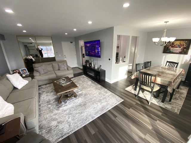 living room with dark hardwood / wood-style flooring and a chandelier