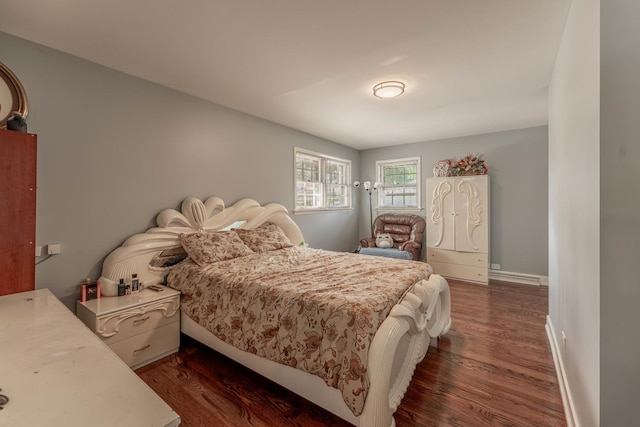 bedroom with dark hardwood / wood-style floors